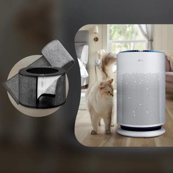 A cat stands next to an air purifier in a living room.