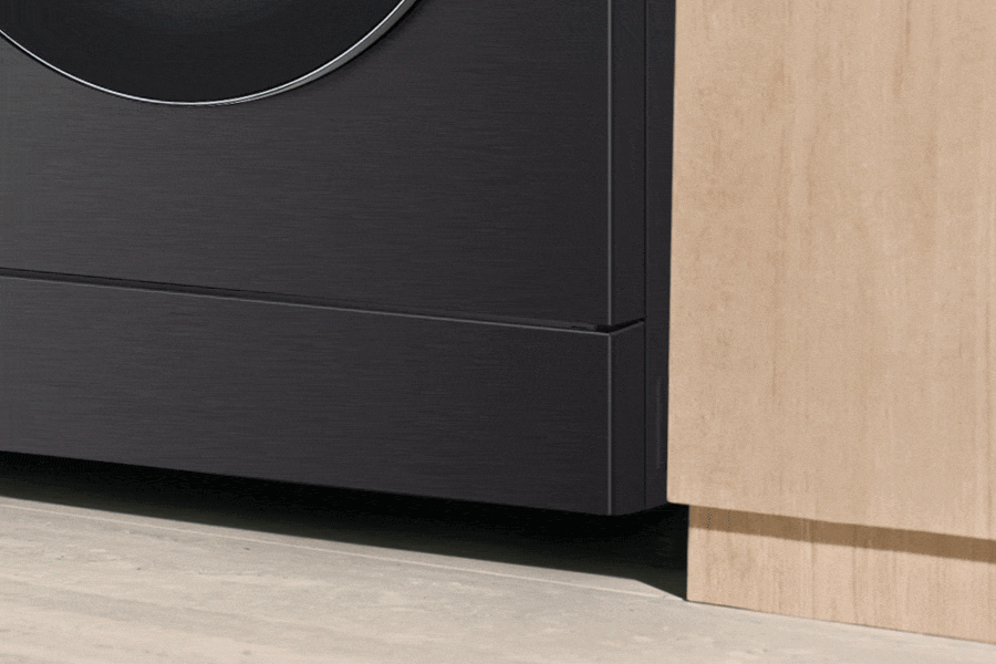 LG WM9998HBA Washer Dryer Combo with One Less Feature pedestal base in modern laundry room setting