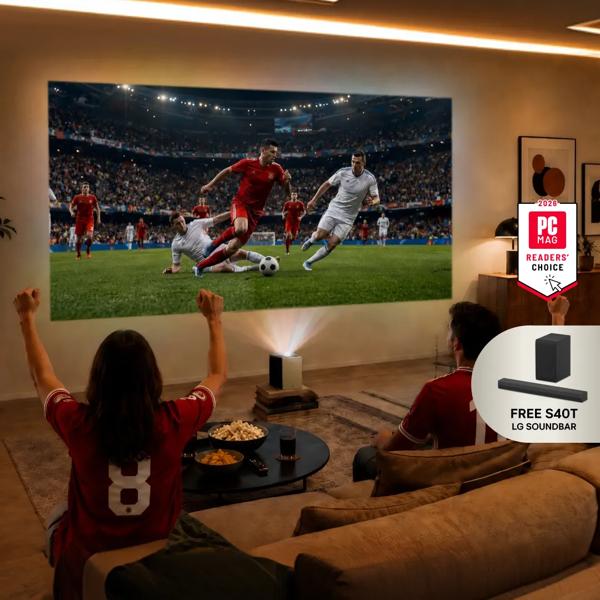 A group of friends watch a soccer screen with an LG projector from a living room. “Game Changers Event 2026”, “FREE LG Soundbar” pop-out text. “2026 PC MAG Readers’ Choice” badge.