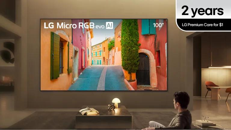 A man watches his LG Micro RGB evo TV from a large and stylish living room setting.