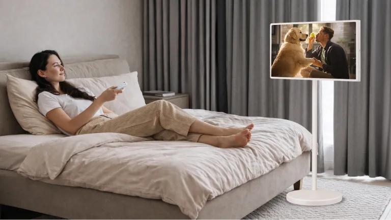 A woman watches a scene on her StanbyME 2 Portable Smart Touchscreen.