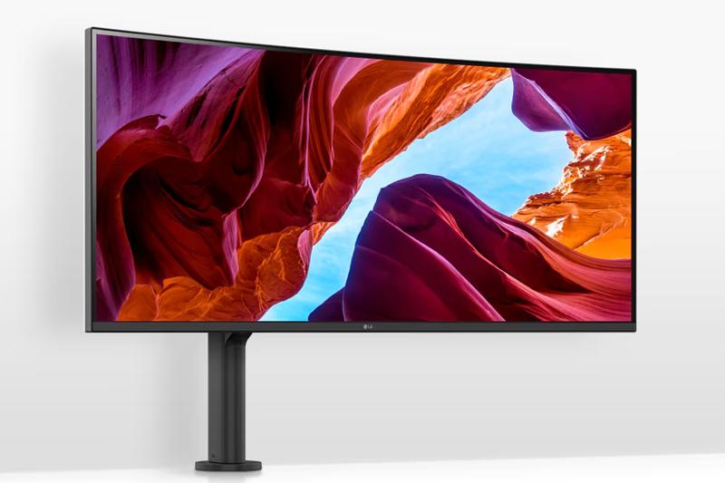 A computer monitor displaying a colorful canyon scene with red and orange rocks against a blue sky.