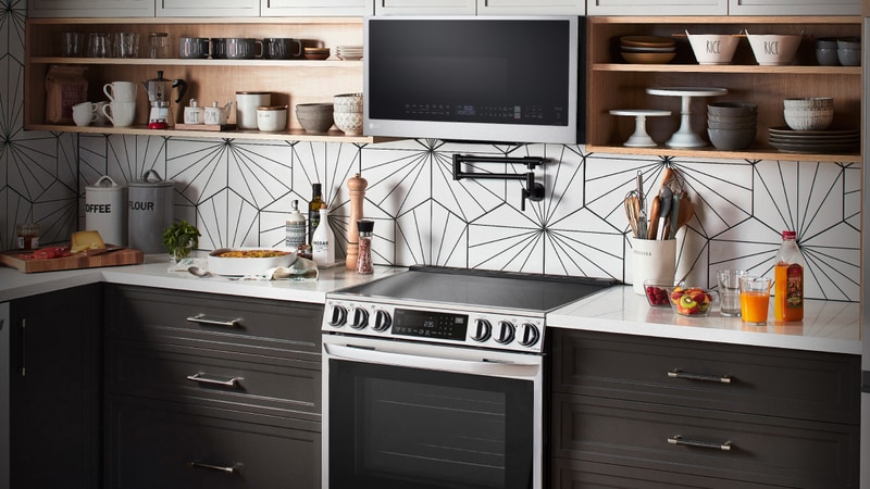 An LG Cooktop and over-the-range-microwave appear in .a bright kitchen setting. 