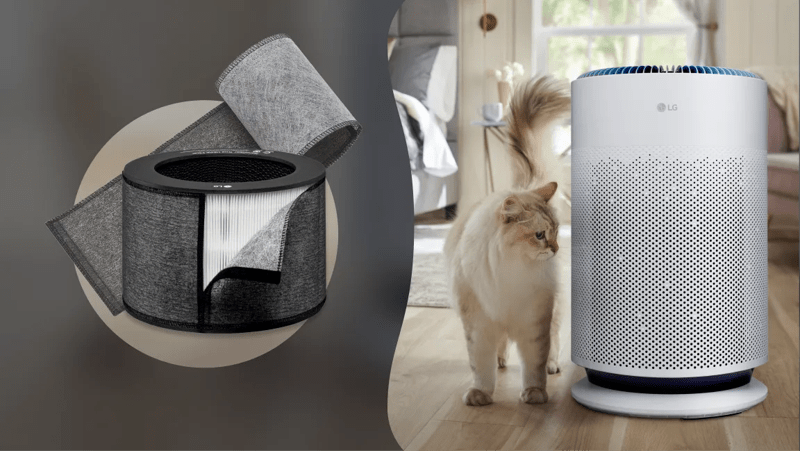 A cat stands next to an air purifier in a living room.