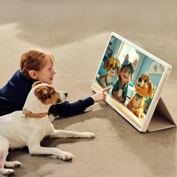 The LG StanbyME 2 27 Inch Portable Smart Touch Screen being used by a child with her dog next to her on the floor.