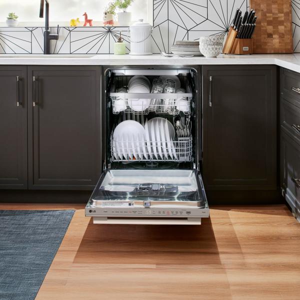 An open LG dishwasher in a kitchen setting