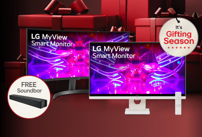 “It’s Gifting Season” badge. A pair of black and white LG MyView smart monitors appear in front of a graphic of a group of red gift boxes. A pop-out of image for a “free soundbar” appears next to the monitors. 