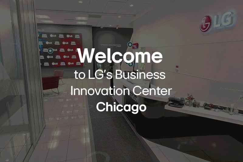 A GIF showing the opening animation of the Chicago BIC's virtual tour. A distant view of the BIC Floorplan is seen on a black background, which then rotates and zooms towards the viewer until the audience is virtually placed in the BIC's reception area, ready to begin the virtual tour. As this happens, the screen darkens slightly and the words 'Welcome to LG's Business Innovation Center Chicago' appear in white.
