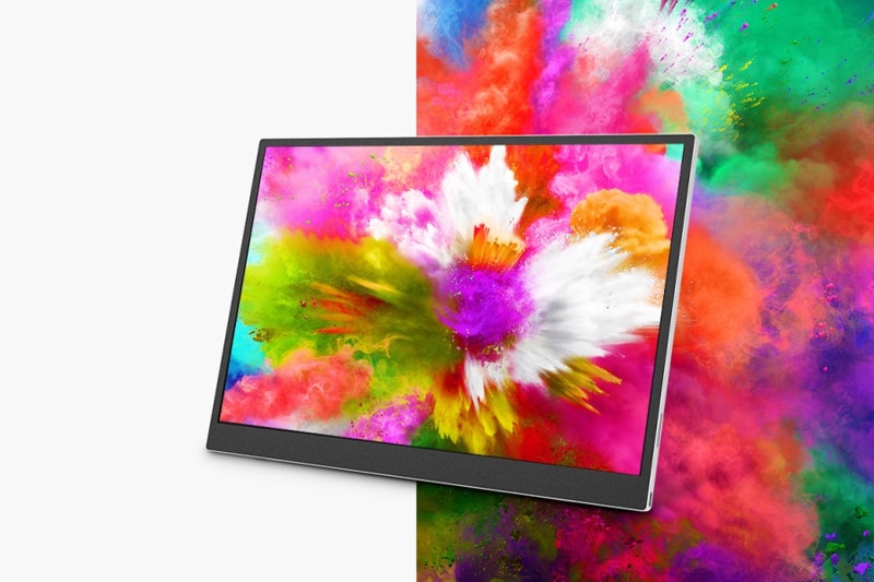 A monitor displaying a vibrant explosion of colors, blending with a colorful background.
