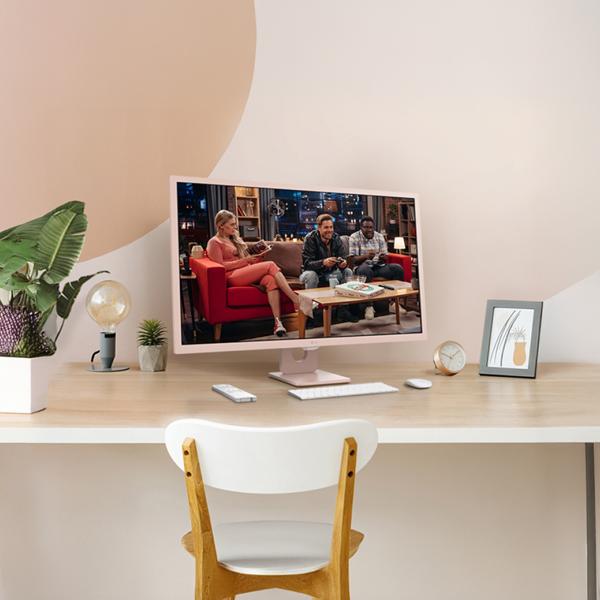A pink MyView Smart Monitor appears on a desk in sunny office setting. 