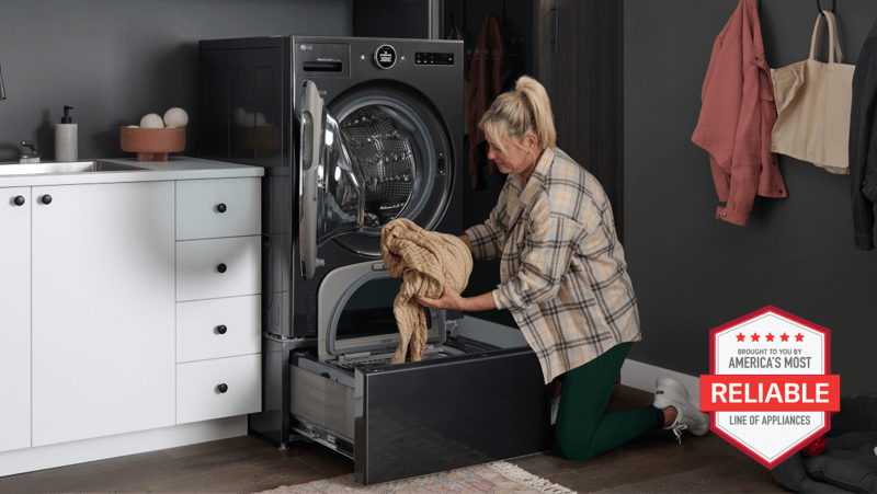 A woman unloads laundry from her pedestal washer, situated directly below an LG WashCombo. “America’s Most Reliable Line of Home Appliances” badge.