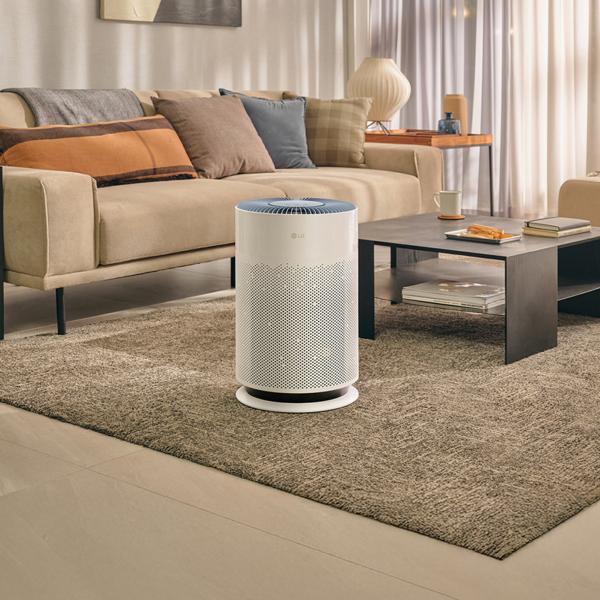 An LG PuriCare air purifier appears in a stylish living room setting. 