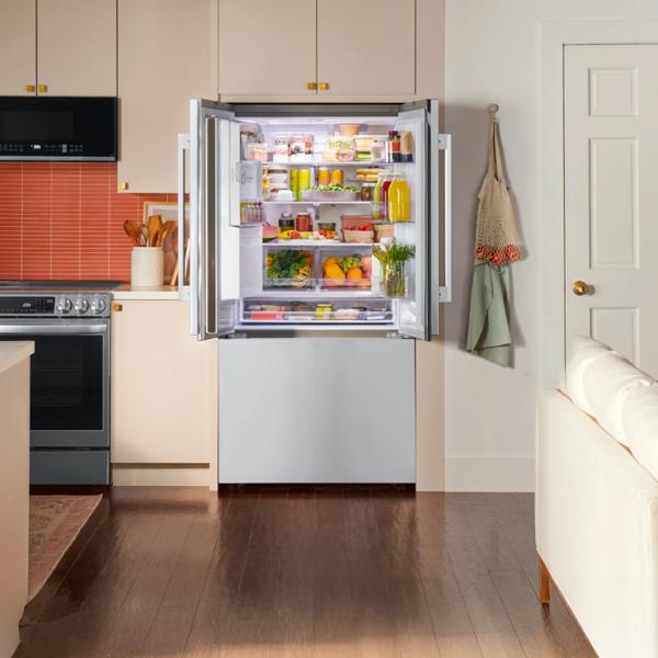 An open LG refrigerator in a bright kitchen setting.