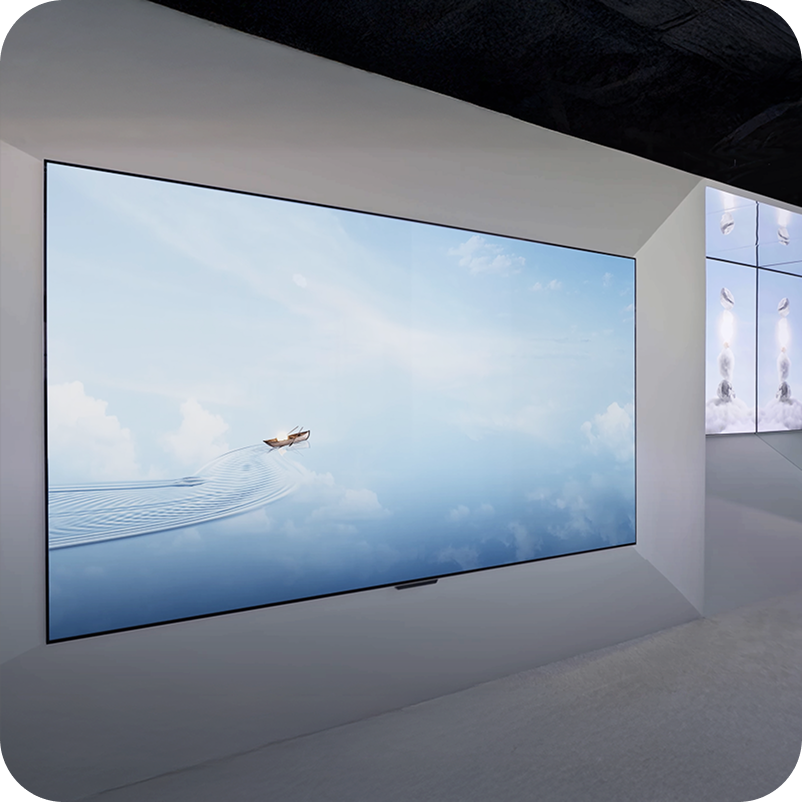 LG OLED TV mounted on a wall and displaying digital art piece of a boat on water and clouds, showcasing the screen's brightness and color accuracy.