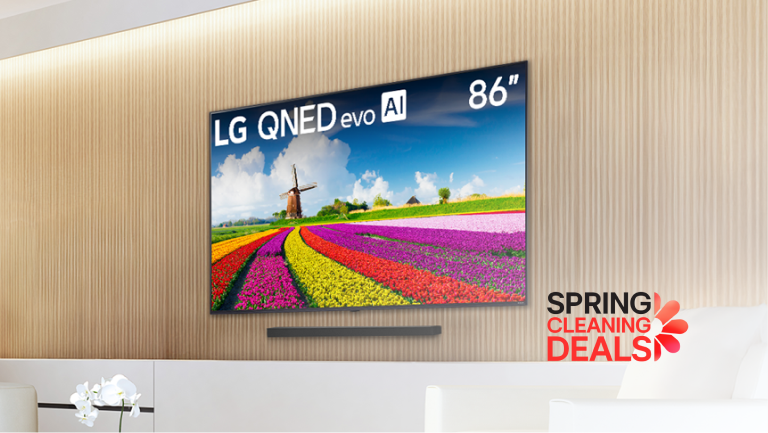 Modern living room featuring an 86-inch LG QNED evo AI TV displaying a vibrant image of a tulip field and windmill, with a “Bright Room Ready” badge and “Spring Cleaning Deals” promotion.