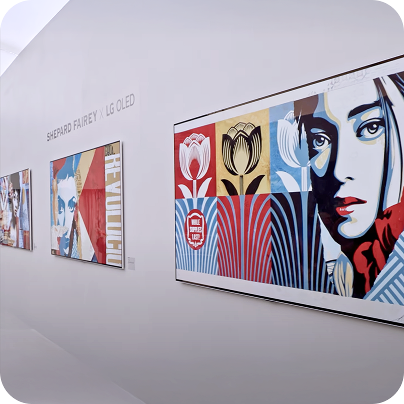 A gallery of LG OLED screens mounted on a wall and featuring vibrant digital art from artist Shepard Fairey.