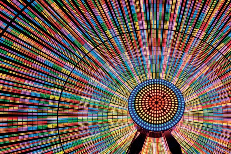 A multicolored circular pattern with concentric dots and radial lines.