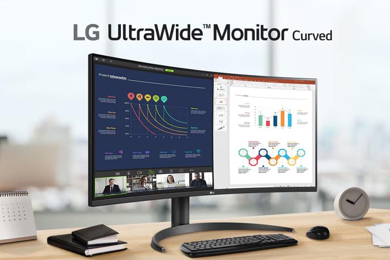 Curved LG UltraWide Monitor on a desk displaying graphs and video conferencing.