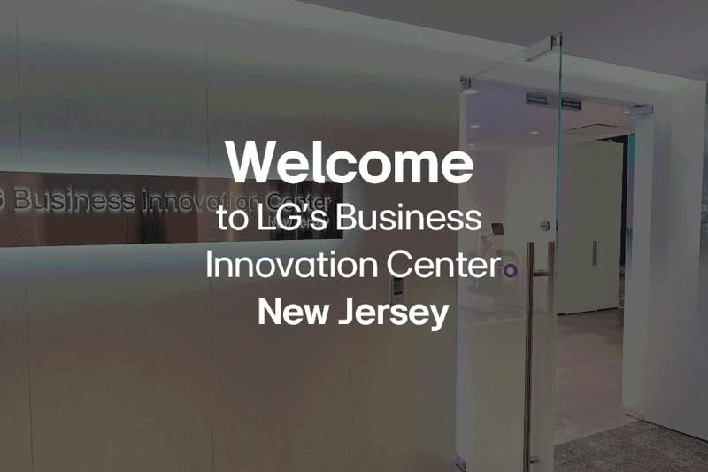 A GIF showing the opening animation of the New Jersey BIC's virtual tour. A distant view of the BIC Floorplan is seen on a black background, which then rotates and zooms towards the viewer until the audience is virtually placed in the BIC's reception area, ready to begin the virtual tour. As this happens, the screen darkens slightly and the words 'Welcome to LG's Business Innovation Center New Jersey' appear in white.