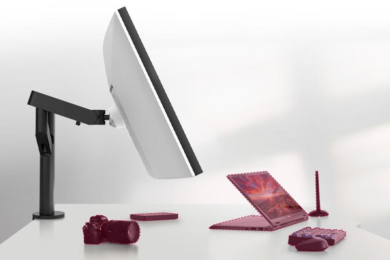 A workspace with a large lg monitor on an adjustable arm, a red laptop, and accessories on a white desk.