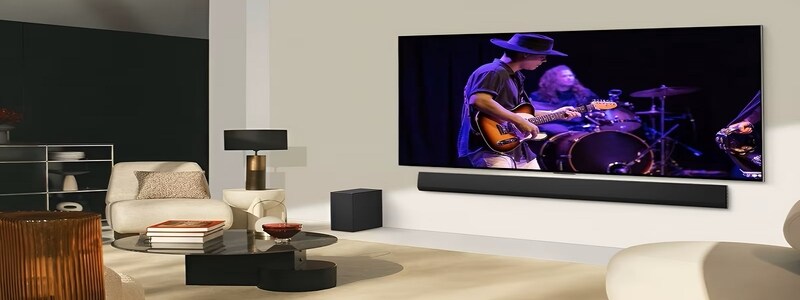 LG OLED TV paired with a soundbar delivering a live music performance, perfect for gamers who want top-tier sound and picture quality.

