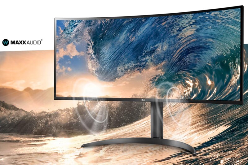 Curved monitor displaying a vivid image of ocean waves with a MAXXAUDIO logo in the corner.