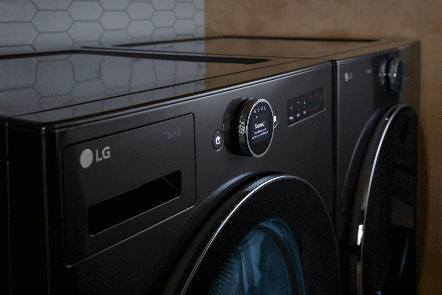 Close-up of controls of a dark gray front-load washer.