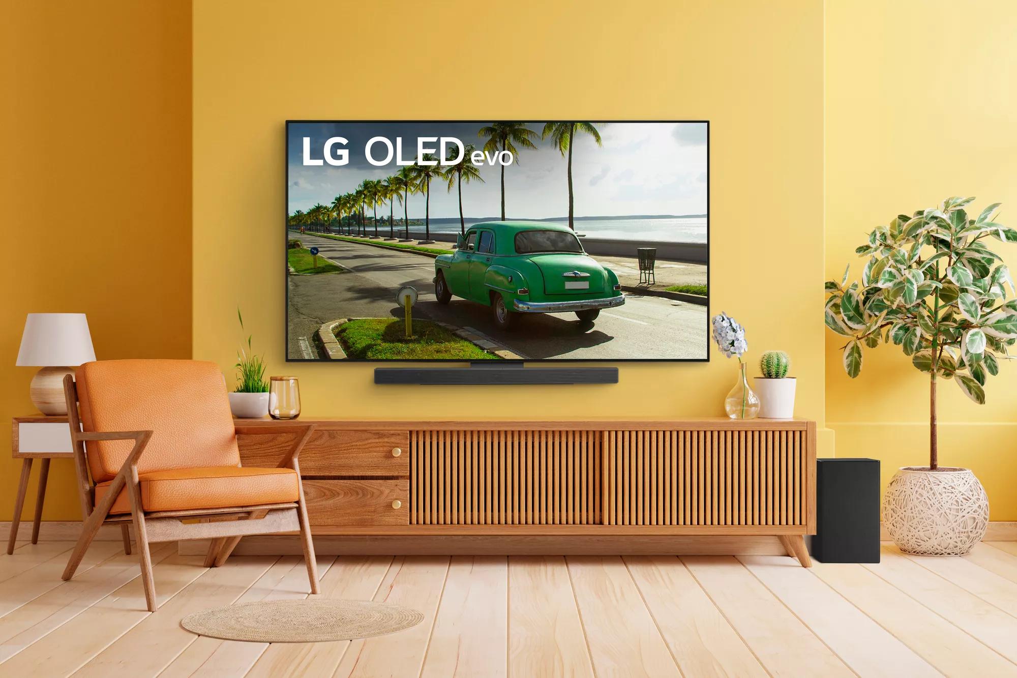 LG SC9S Soundbar with LG OLED evo Series C TV Mounted on Yellow Wall