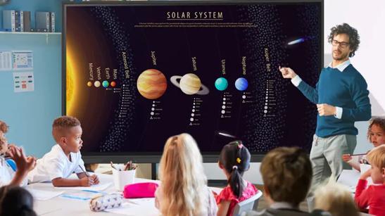 A kindergarten teacher uses an LG CreateBoard to teach his class about the solar system.