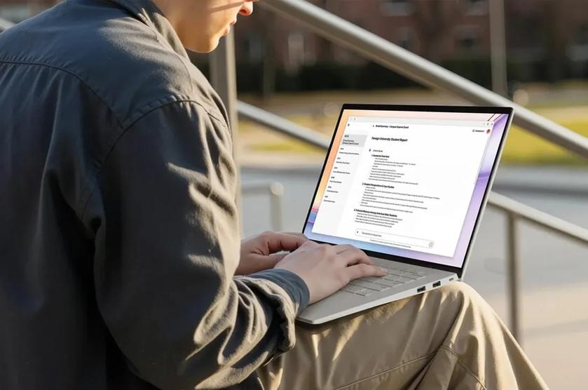 A young professional works remotely with LG gram laptop, looking over a document while sitting on a sports field bleacher