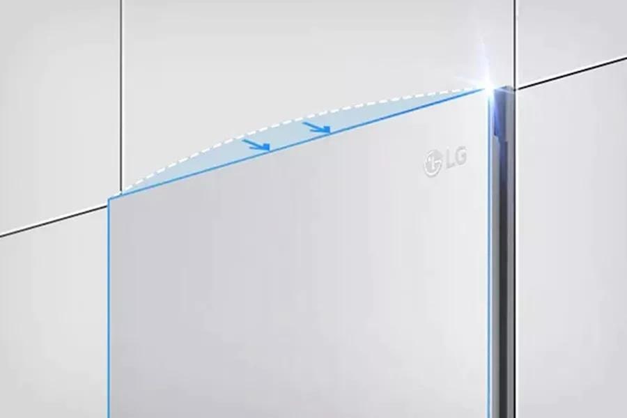 A side angle of the top of the single door stainless steel refrigerator in a wall of surrounding white cabinets. The door is outlined in blue with two blue arrows pointing into the wall to demonstrate the flat door design that blends seamlessly into kitchen cabinets.