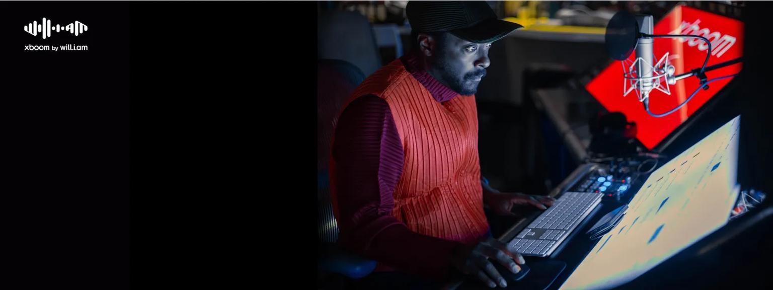 MINI_ANOALBK xboom portable speaker tuned perfection feature showing music producer in studio with laptop and professional microphone