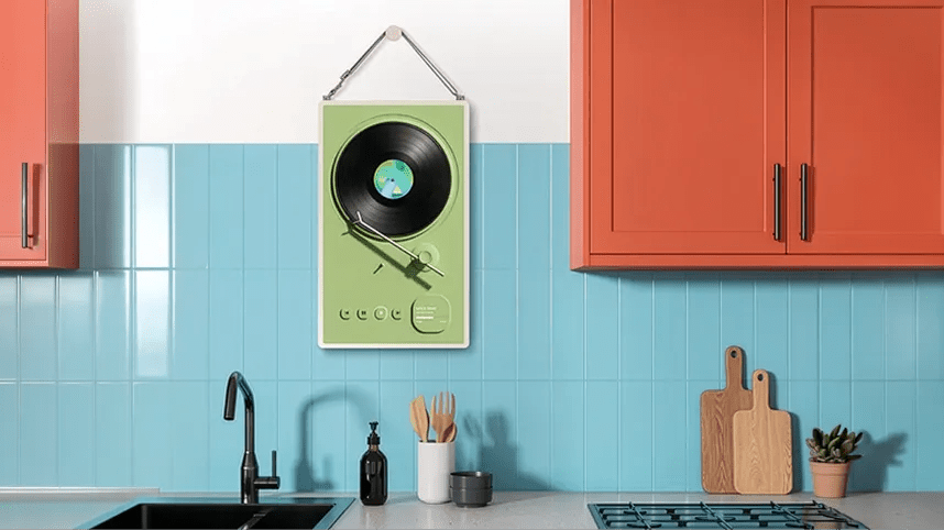 LG StanbyME 2 displayed as a digital picture frame in a kitchen, showing a vinyl record player illustration.