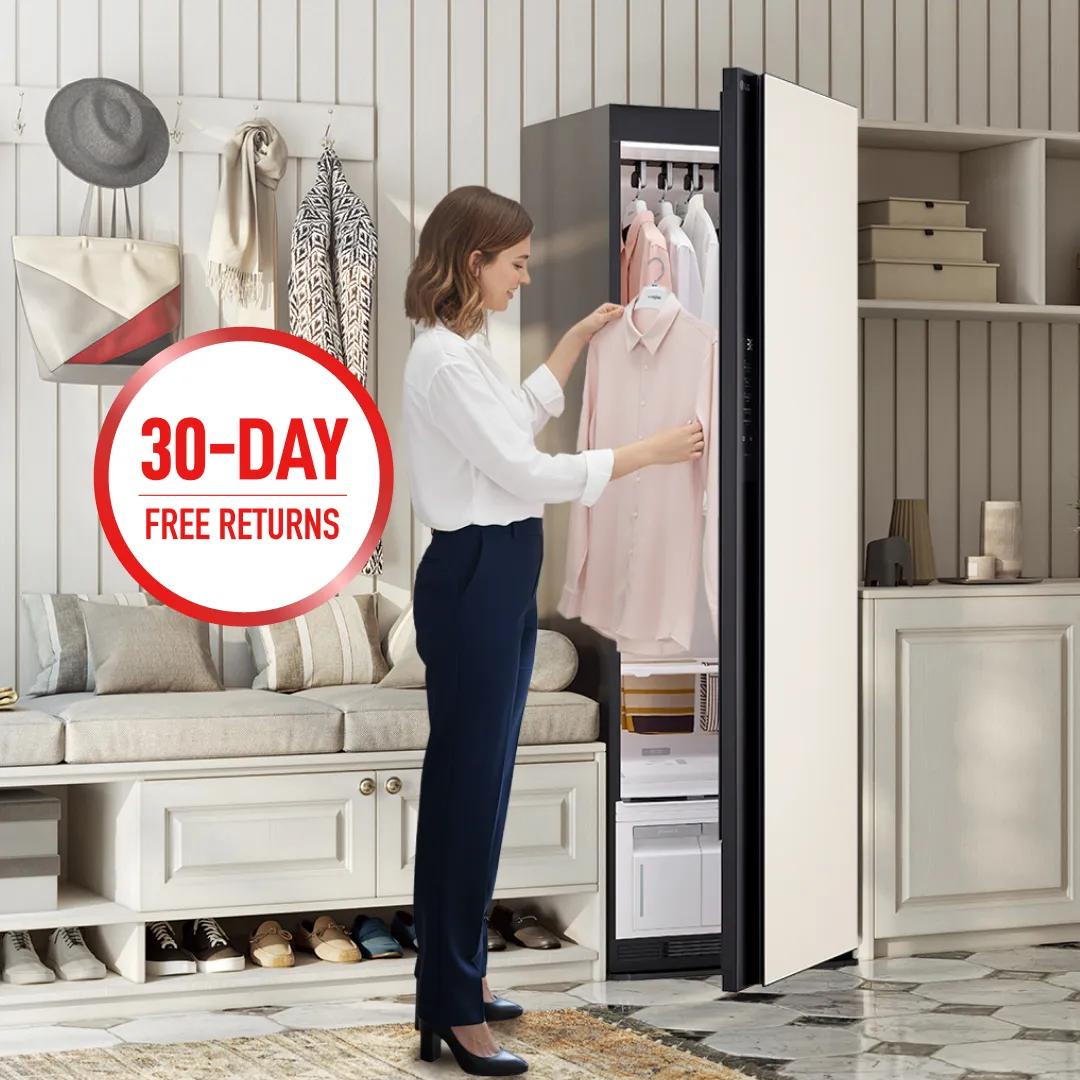 LG Styler® Steam Closet appears in bright living room setting as woman removes a freshly steamed blouse. “30-Day Free Returns” badge.