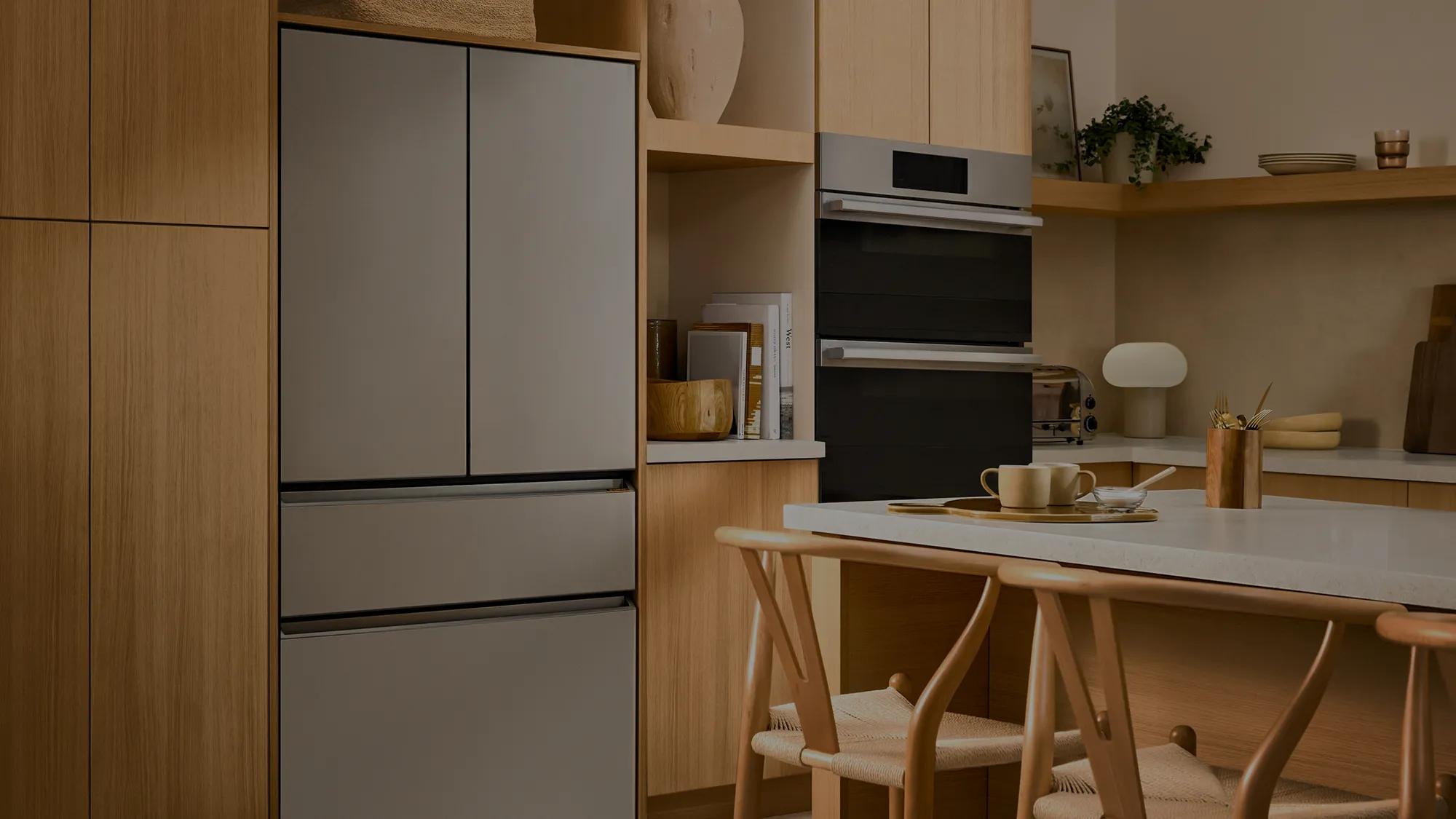 LG SIGNATURE refrigerator and wall oven integrated into a kitchen with cabinetry and island seating