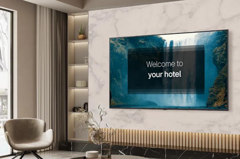 Modern hotel lobby with a TV displaying "Welcome to your hotel."
