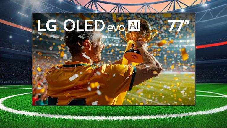An LG OLED TV appears on a soccer stadium field. Image on TV shows a player celebrating as they hold a trophy.