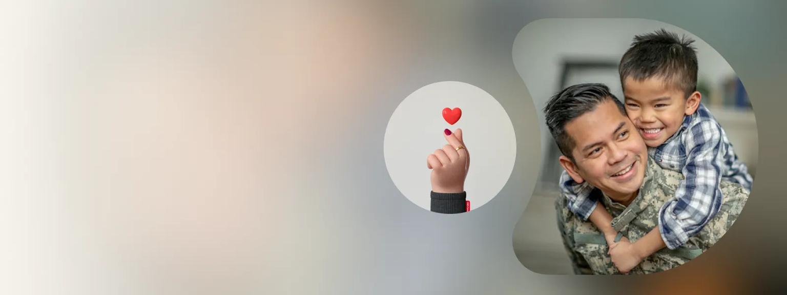 A soldier in full uniform smiles as a young boy hangs from his back playfully. A 3D graphic of a hand holding up a small heart appears beside it.