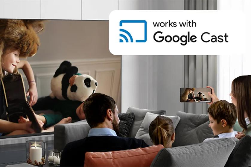 A family watches a movie on a UJ661H Hotel TV using Google Cast from a smartphone.