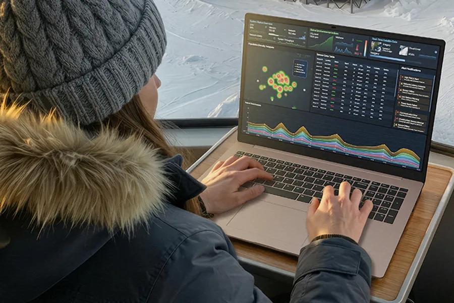 LG Gram 17Z90UB-H.AU75U3 laptop displaying data analytics dashboard with colorful graphs and charts while being used in winter setting