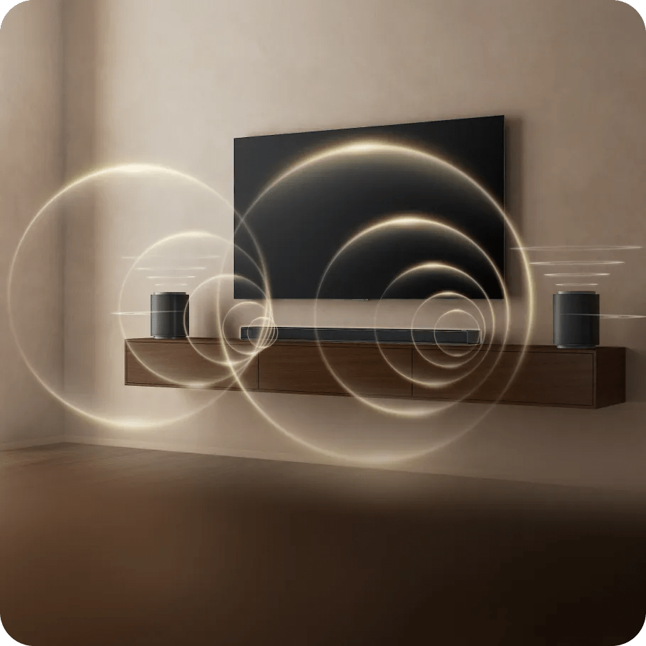 Wall-mounted TV with an H7 Soundbar and two wireless speakers on a floating shelf, emitting circular sound waves.