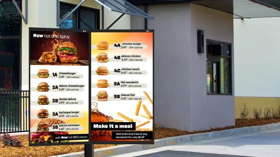 LG Drive Through digital signage outside of a restaurant drive through, featuring bright menu for a burger quick serve restaurant.