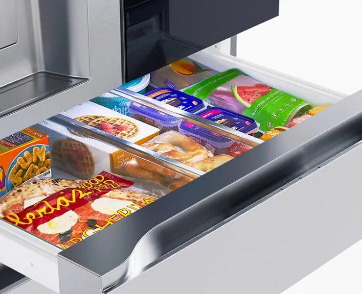 Interactive image showing an open Full-convert Drawer stocked with drinks, snacks, and bottles. The contents change based on the user’s selected temperature setting, updating to display foods and beverages suited for each zone such as chilled wine, deli items, cold drinks, meat or seafood, or frozen goods.