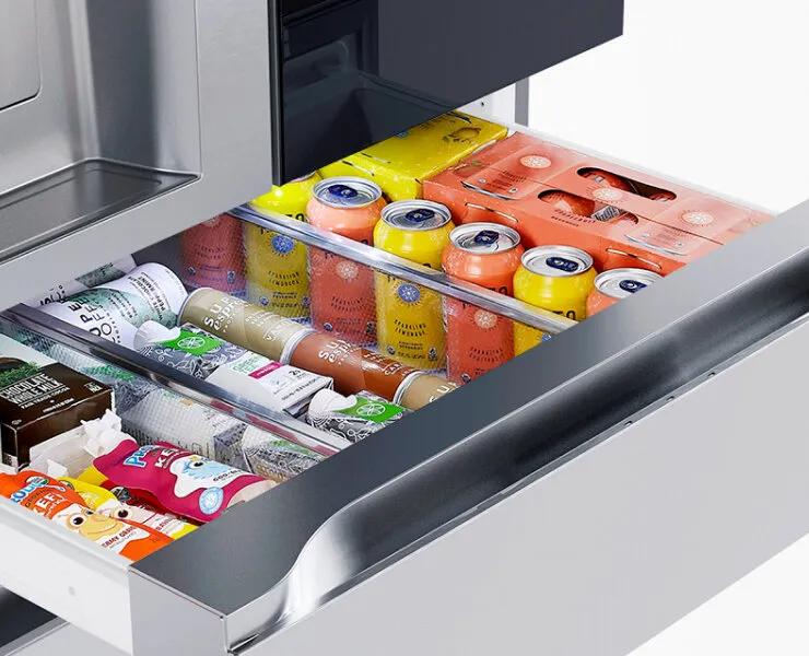 Interactive image showing an open Full-convert Drawer stocked with drinks, snacks, and bottles. The contents change based on the user’s selected temperature setting, updating to display foods and beverages suited for each zone such as chilled wine, deli items, cold drinks, meat or seafood, or frozen goods.
