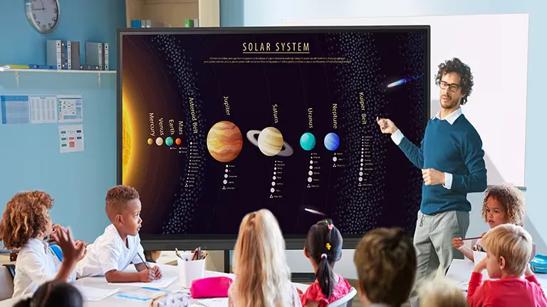 A kindergarten teacher uses an LG CreateBoard to give a lesson about the solar system.