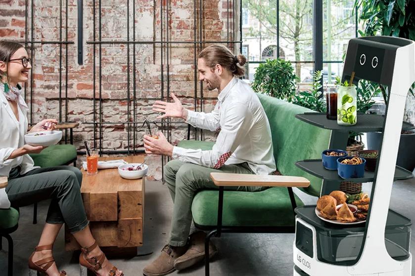 CLOi is delivering food to a young stylish couple in an upscale cafe restaurant.