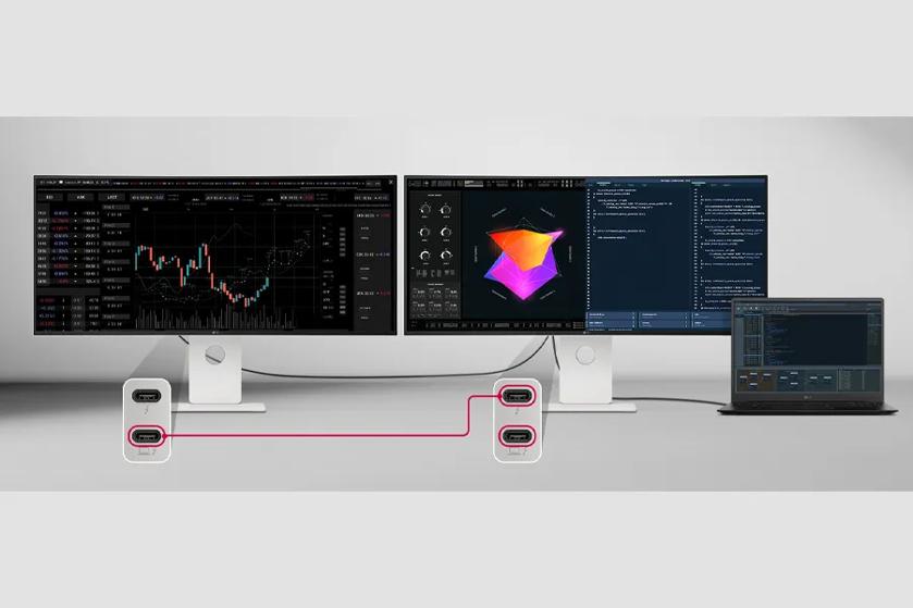 Workspace with two monitors displaying data charts, a laptop, and connected devices.