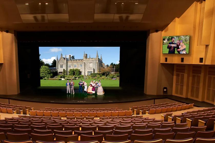An LG DVLED Display forms a vivid backdrop for actors in a school theater. Signage on the wall offers audiences c  a closer look at what's happening on stage.