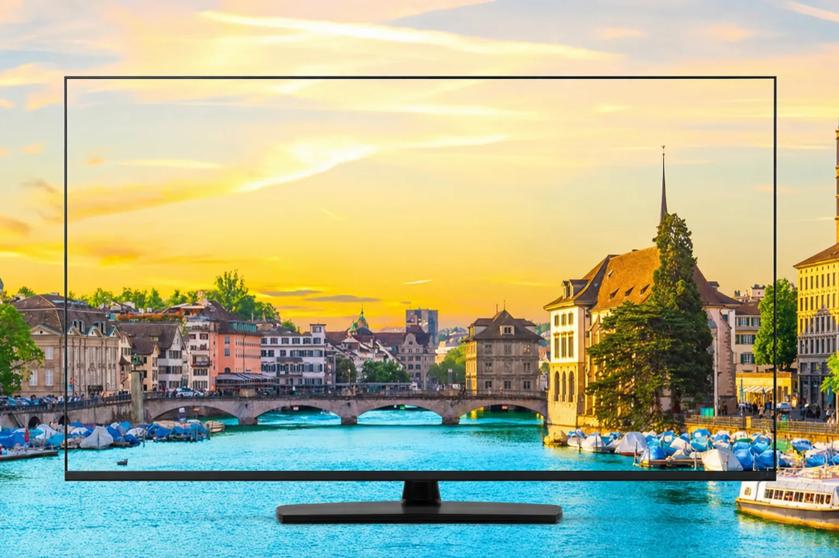 Hotel TV showing a bright city scene, with the same image as the background. The brilliant colors make the image seem seamless. 