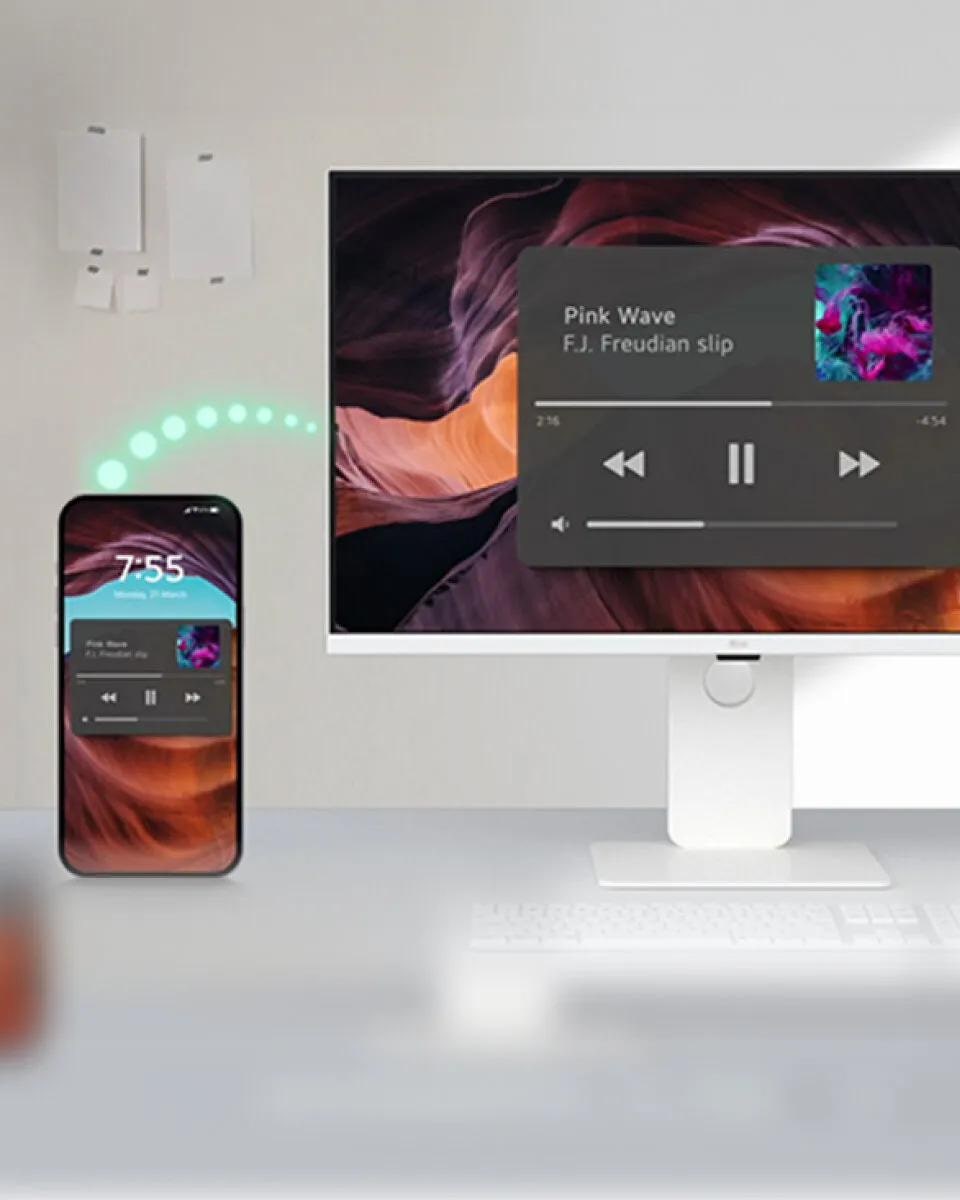 Smartphone paired with LG Smart Monitor via Bluetooth and playing a music app.